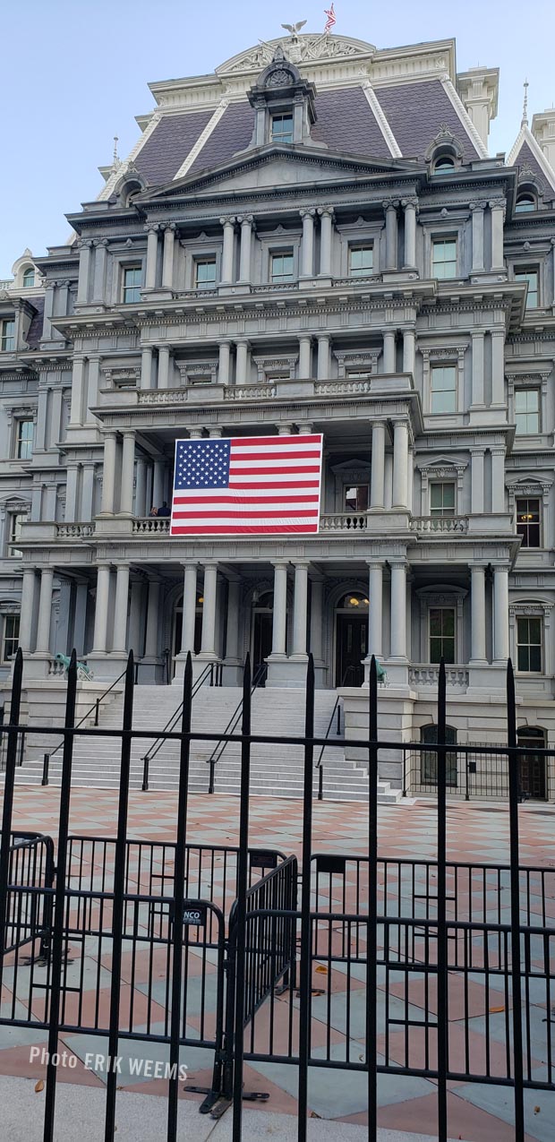 American flag hung on front of the Old Executive Office Building 