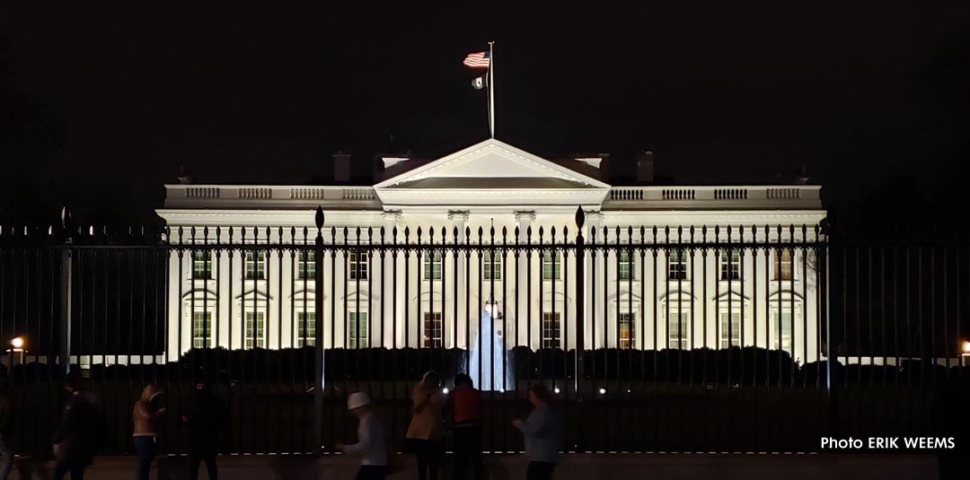 White House at night with fountain and tall fence
