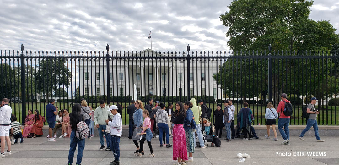 Iranian protest group before the White House under cloudy skies